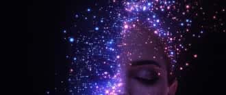 Portrait with glowing particles across a dark face